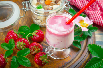 Sweet strawberry and healthy, wholesome food in composition on the table.