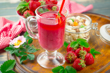 Fruit cocktail from fresh strawberries on the kitchen table.