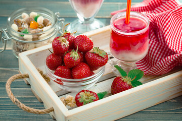 Fruit cocktail from fresh strawberries on the kitchen table.