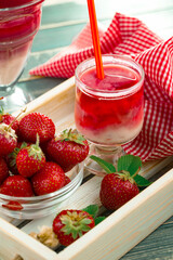 Sweet strawberry and healthy, wholesome food in composition on the table.