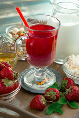 Sweet strawberry and healthy, wholesome food in composition on the table.