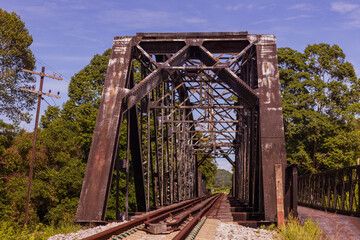 The old railway bridge is made of steel for over 70 years. Rusted and dirty. Located in Southeast Asia