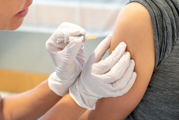 horizontal view of female doctor vaccinating a female patient