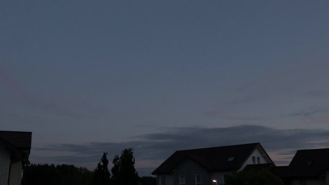 Time-lapse of clouds moving over a village