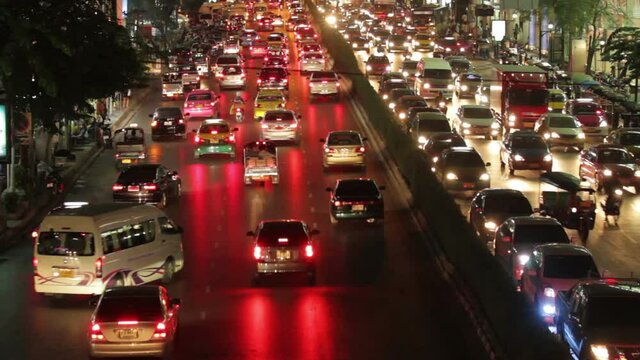 Time lapse of Bangkok car traffic rush hour in Siam center district at night
