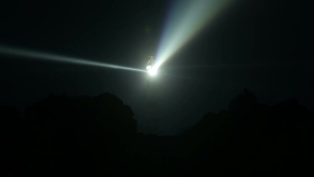 Very powerful Creach lighthouse illuminated in evening, Ushant island, France