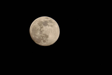 Close up of full moon on the dark night