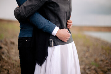 The bride together with the groom stand in a dress and suit