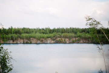 Rocks and mountains with forest on nature. Stones near the lake