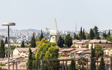 Obraz premium View of the famous Montefiori Windmill, built in 1857, from the Jaffa Gate in the old city of Jerusalem, Israel