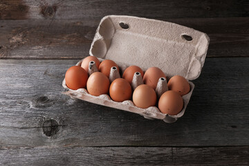 Homemade farm eggs on a wooden background with copy space, natural products
