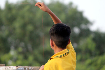 a children is trying to flying a kite but their kite is not flying