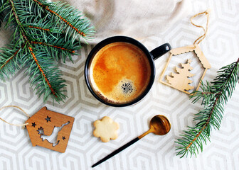 
cup of coffee with cookies and spruce branches on the table. Christmas atmosphere. holiday card.