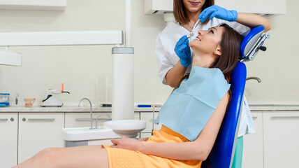 patient is receiving dental treatment in dentist clinic