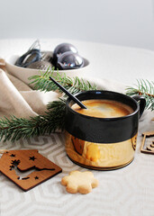 Christmas background with place for text. Christmas balls and spruce branches with a cup. holiday card with lights and a cup of coffee. view from above.