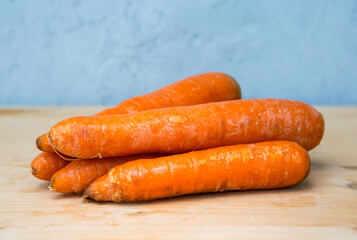 carrots on wooden table with grey background