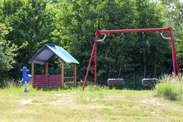 Childrens playground surrounded by trees and foliage