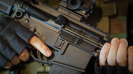 Abstract closeup of security contractor holding an AR15 Rifle