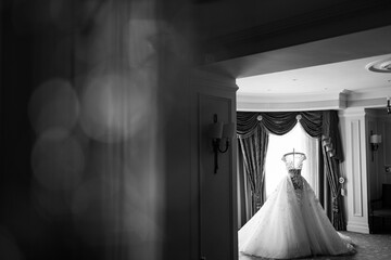 bride's wedding dress on a mannequin. Near the window.