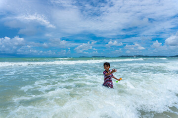 Asian kid play in the sea
