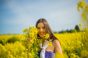 country women in a good mood walks in a rape field
