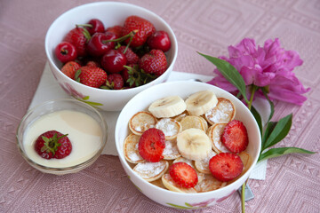 Tasty trendy breakfast - mini cereal pancakes with strawberry, banana and sugar powder.