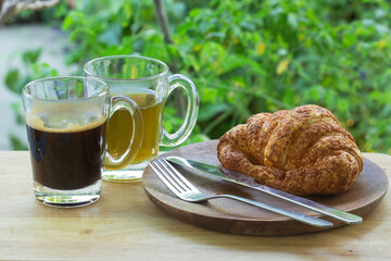 Thai Black Coffee and hot Tea with croissant bread on  Wooden Bar