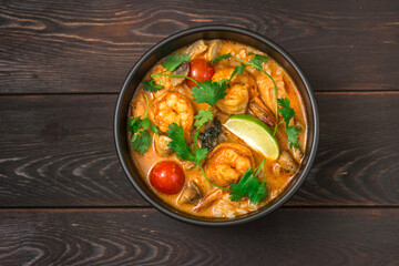 Tom yam traditional thai meal on wood table. Top view