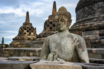 Buddha in a temple with stupas 