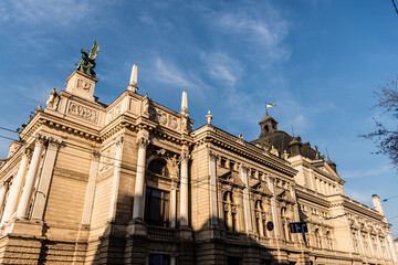 Fototapeta na wymiar Lviv Theatre of Opera and Ballet in sunshine against blue sky
