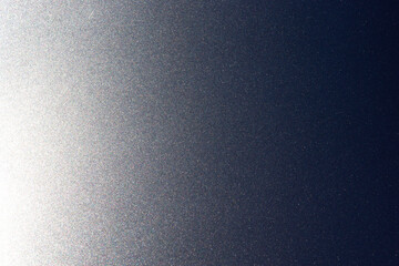 Shimmers on surface of metallic gray lacquered and polished metal background