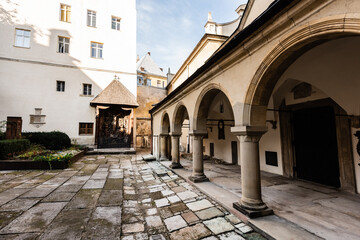 Fototapeta na wymiar inner yard of carmelite monastery with arch gallery in lviv, ukraine