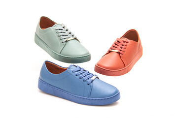 various colorful female sneakers on white background