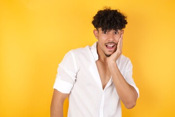 Surprise astonished handsome guy. Closeup portrait of man looking surprised in full disbelief wide open mouth with hand near face. Positive emotion facial expression body language. Funny boy