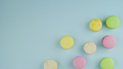Macaroons or macaron on pastel blue surface. Close up.