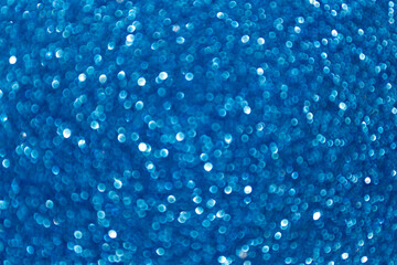 Blurred sparkles, lights with bokeh effect and selectieve focus. Festive background with bright gold lights. Christmas mood concept. Copy space, close up, texture, top view.