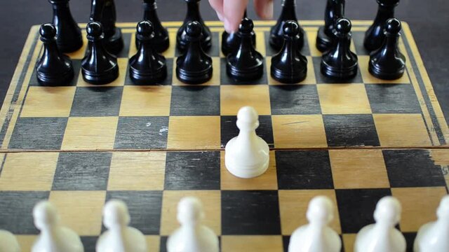 Grandmaster plays chess on a chessboard