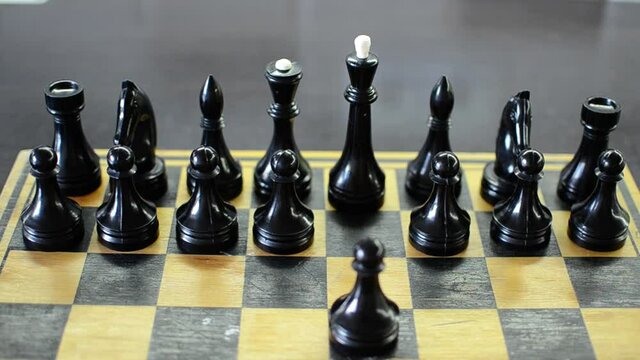 Grandmaster plays chess on a chessboard