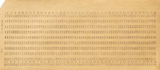 Paper punch card for storing information in the first electronic computers. One punch card. Data storage. Close up. Top view.