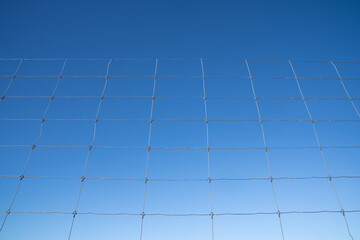 Wire fences with blue sky background copy space.