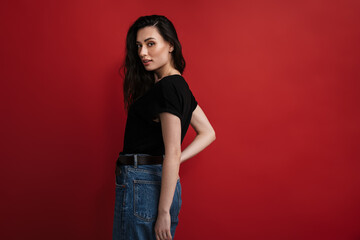 Photo of pleased woman in casual t-shirt posing and looking at camera