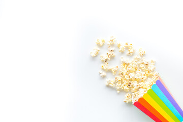 Popcorn in rainbow paper cup top-down copy space