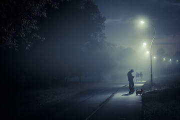 a man walks through a Park in a fog