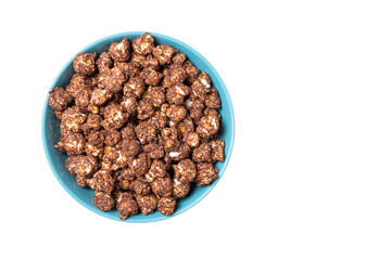 Chocolate popcorn in a blue cup isolated on white background. Top view. Copy space.