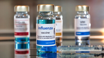 Bottles of influenza vaccine with stainless steel background.