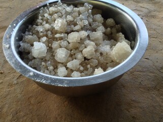 few big salt inside the steel bowl in the floor