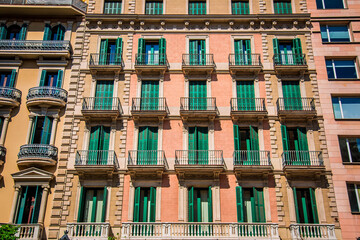 beautiful facades of traditional old historic spanish houses, windows and balconies, located in Spain.