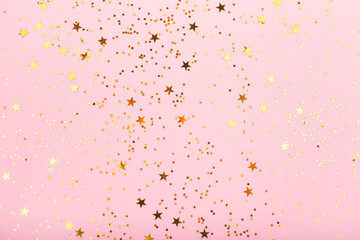 Falling star shape confetti on pink background. Perfect for festive and holidays projects. Copy space for your text.
