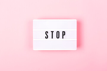The lamp with letters STOP on pink background.