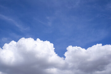 Naklejka na ściany i meble Large white clouds in the indigo blue sky